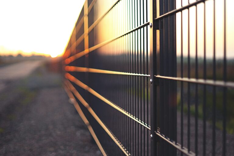 Metal fence marking a commercial property boundary
